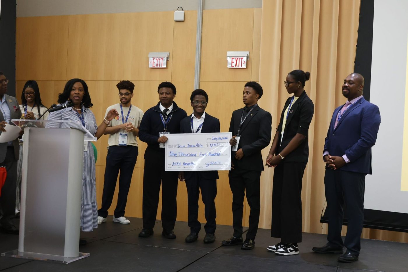 Team InnovAIte on stage holding a $1,500 check, with CEAMLS staff and judges