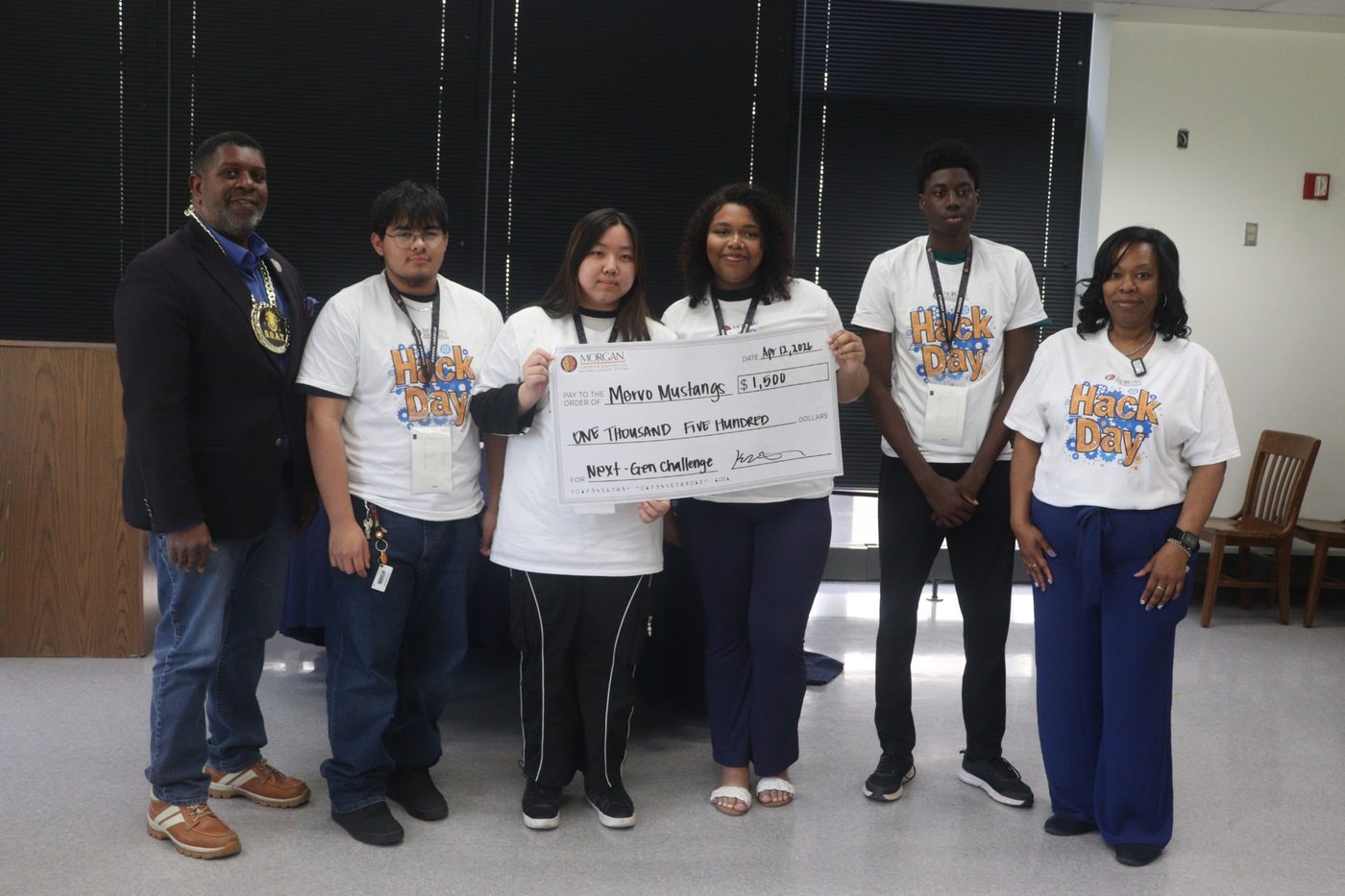 Team Mervo Mustangs holding a $1,500 NextGen Challenge check, with CEAMLS staff
